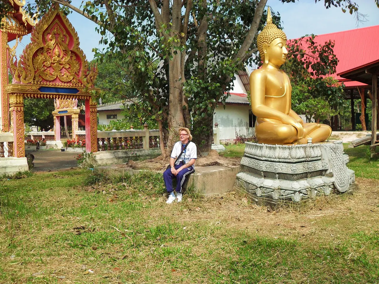 A golden Buddha statue in a temple compound at Non Ngam village, Pathum Ratchawongsa district