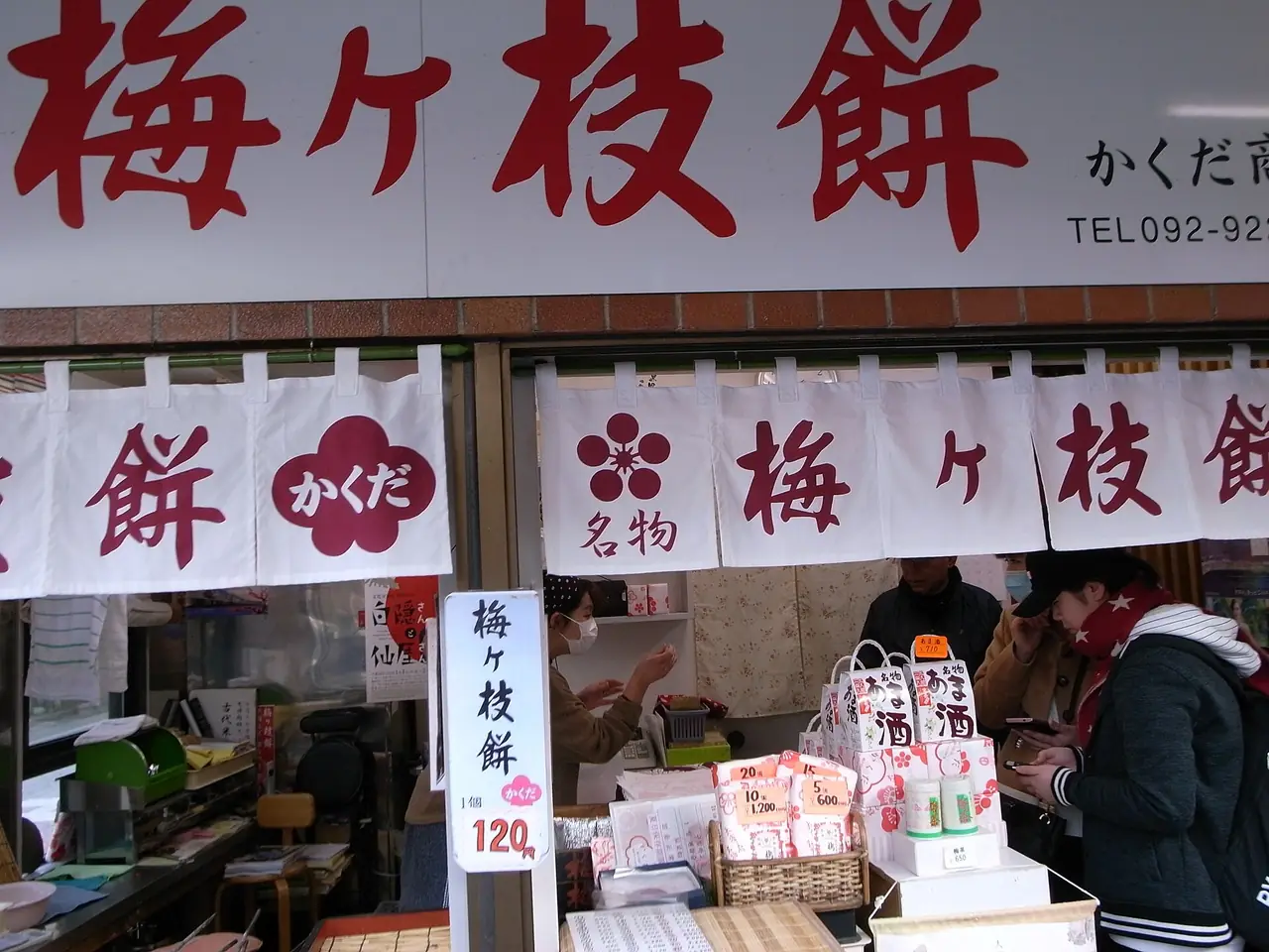 ร้านขายอุเมะงะเอะโมจิบนถนนทางเข้า ตามป้ายชิ้นละ 120 เยน (ภาพจาก Wikimedia Commons ไม่ใช่ราคาปัจจุบัน)
