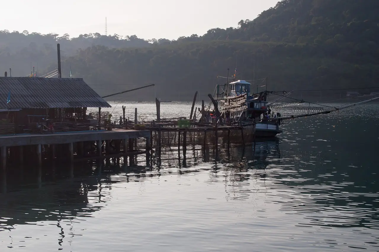 A fishing boat and floating pier in a bay on Koh Kood