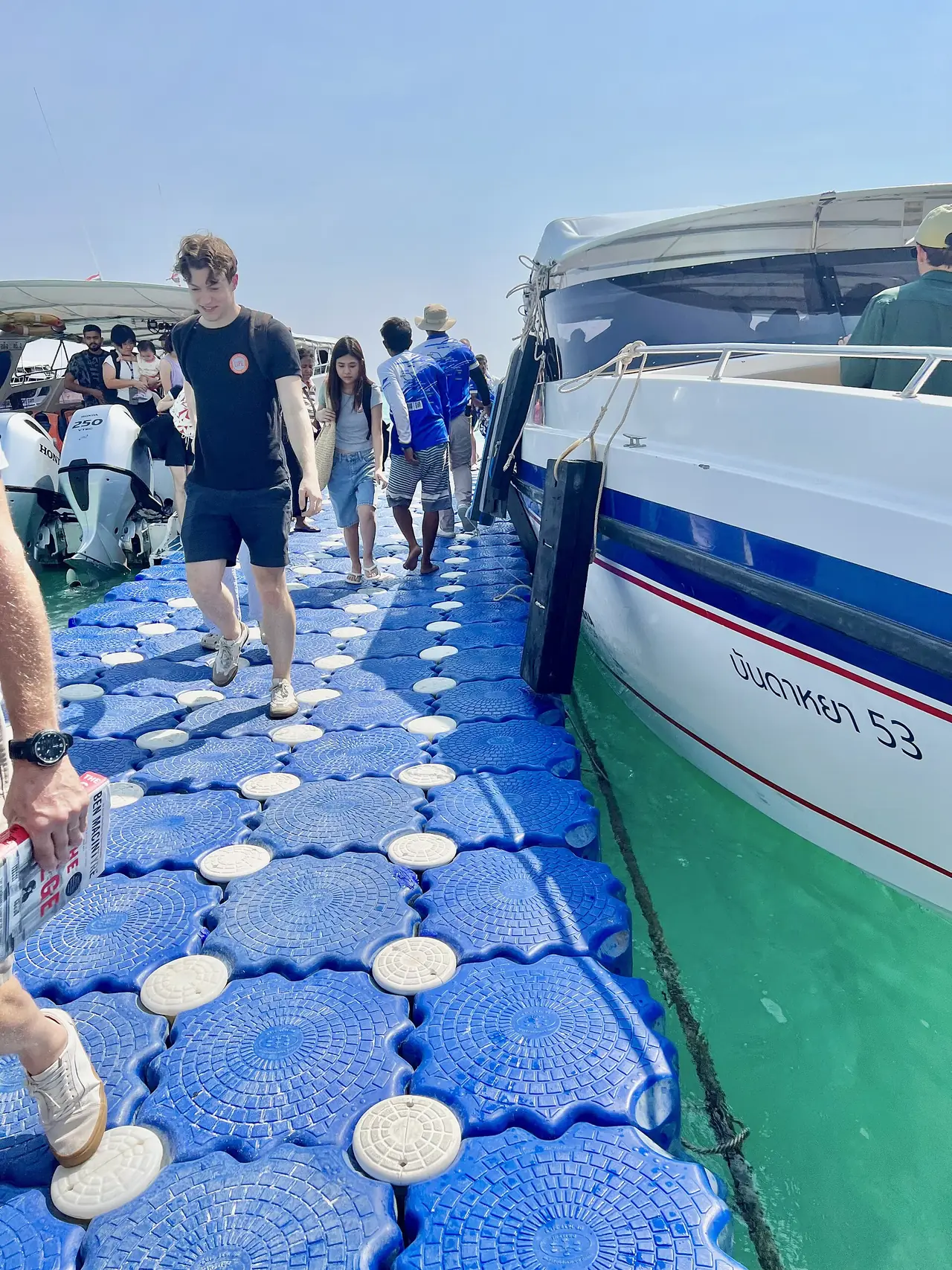 ท่าลอยน้ำสีฟ้าที่เรือสปีดโบ๊ทจอดรับส่งผู้โดยสาร เรือลำข้างๆ เขียนชื่อบัณฑหยา 53 ภาพจาก Wikimedia Commons ผู้ถ่าย Sharon Hahn Darlin ปี 2568 ไม่ระบุว่าท่าไหน