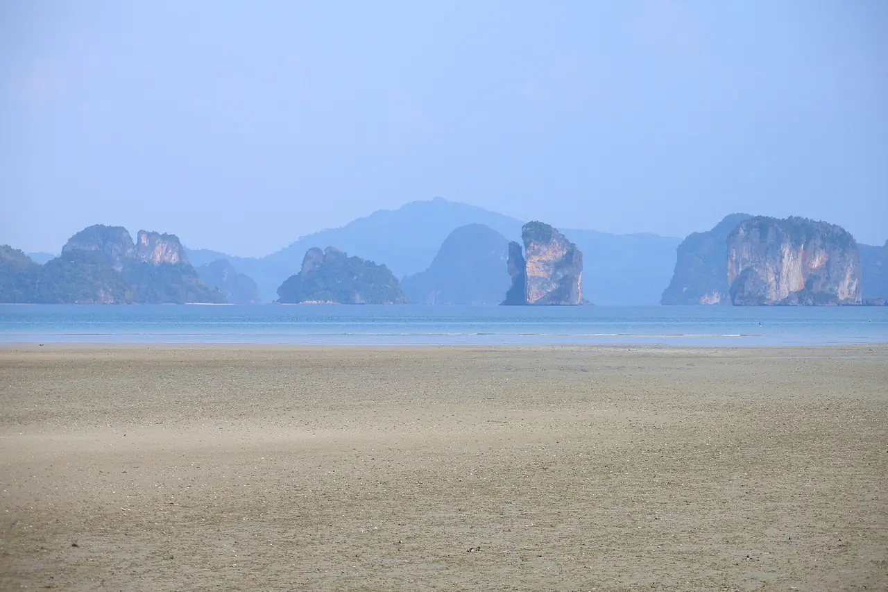 Limestone islands rising from calm water in Phang Nga Bay, seen from Koh Yao Noi