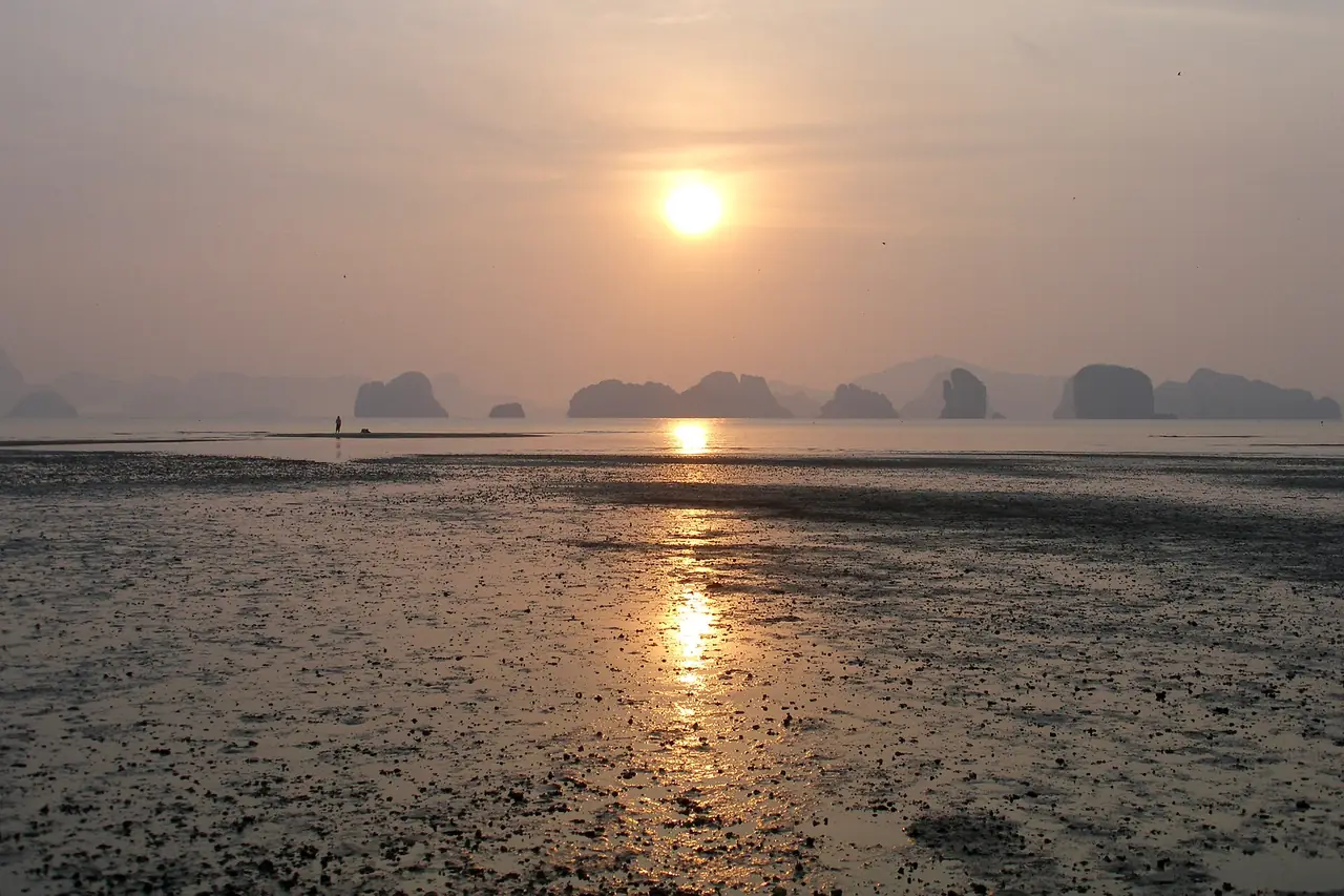 Sunrise over the shore of Koh Yao Noi with the bay's islands on the horizon