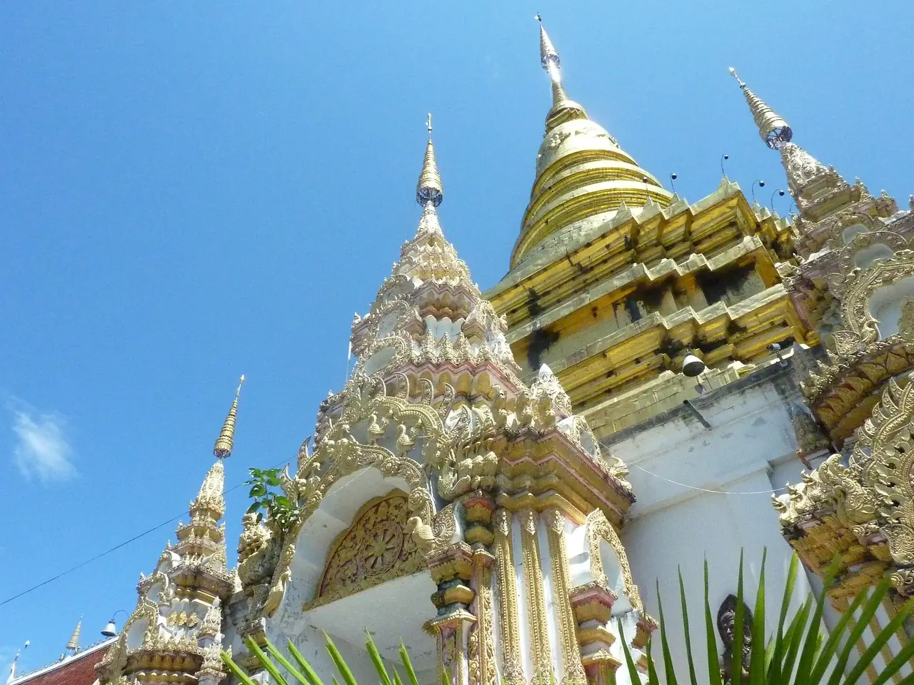 A gilded chedi seen from below at Wat Phra Phutthabat Tak Pha in Pa Sang district