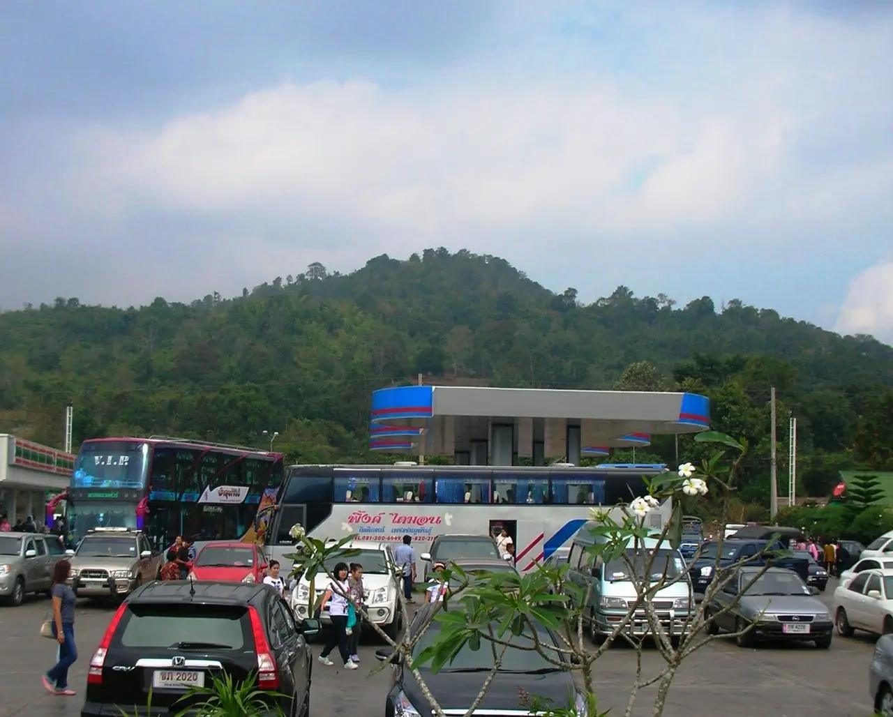 ภูเขาป่าเขียวของภูเรือมองจากทางหลวง มีรถทัวร์และรถยนต์จอดที่จุดแวะด้านหน้า ภาพถ่ายจาก Wikimedia Commons