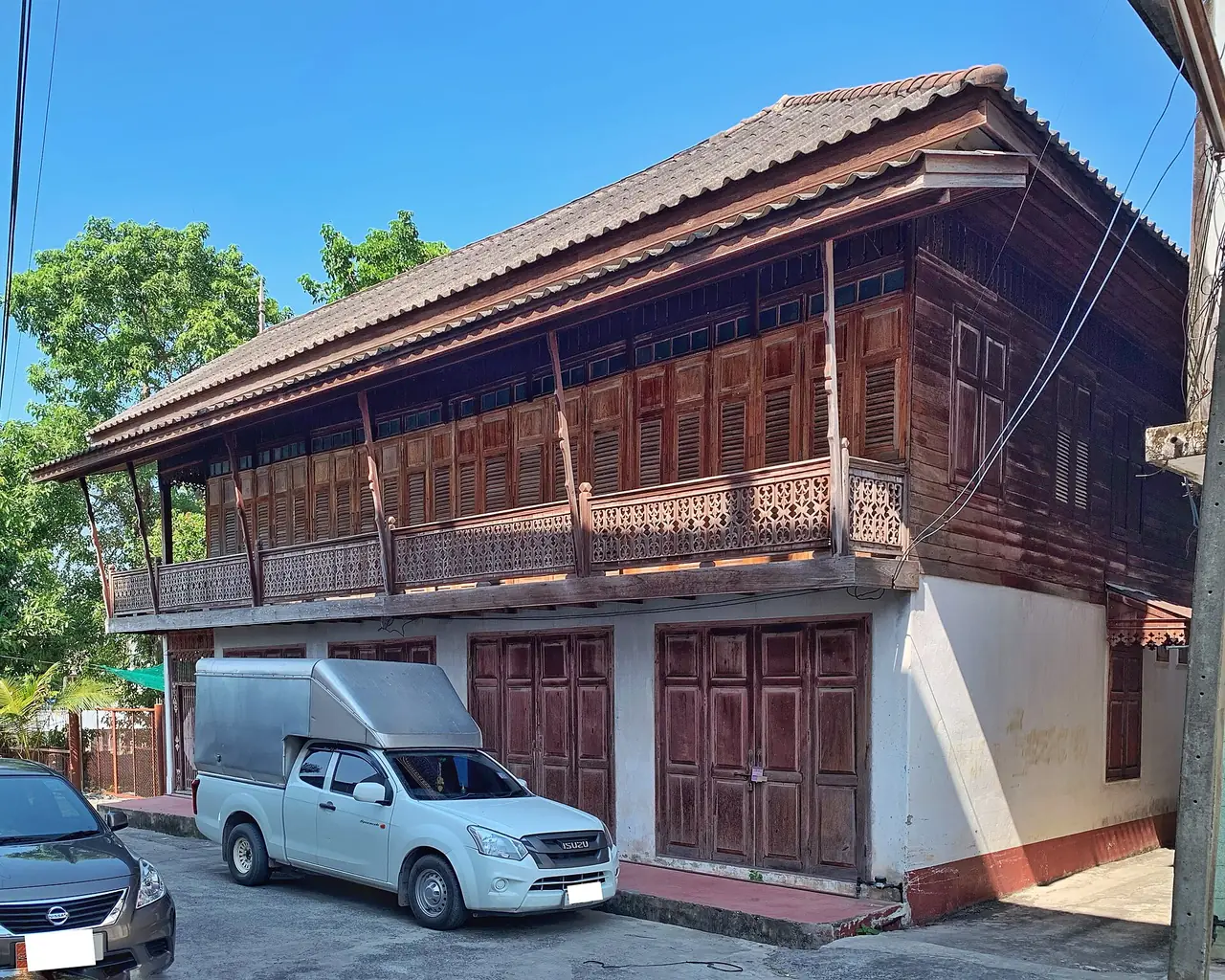 An old two-storey wooden house in Nakhon Nayok town, with carved balcony railings