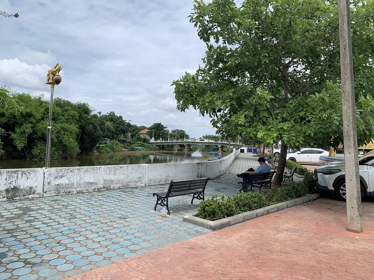 A riverside walkway with benches beside the river in Nakhon Nayok town