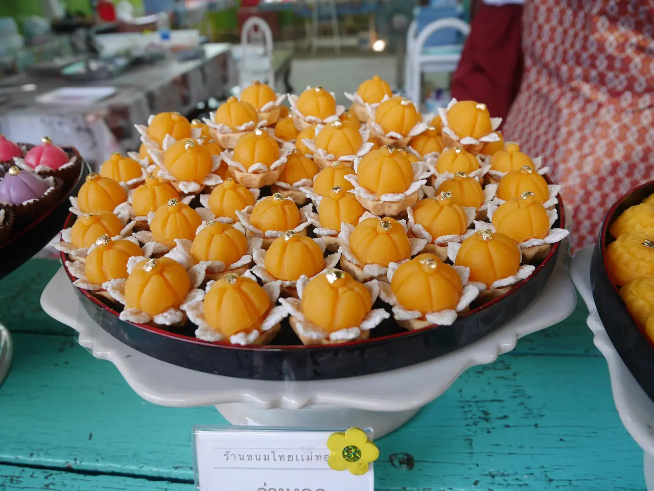 Thai sweets arranged on a stall counter on Ko Kret