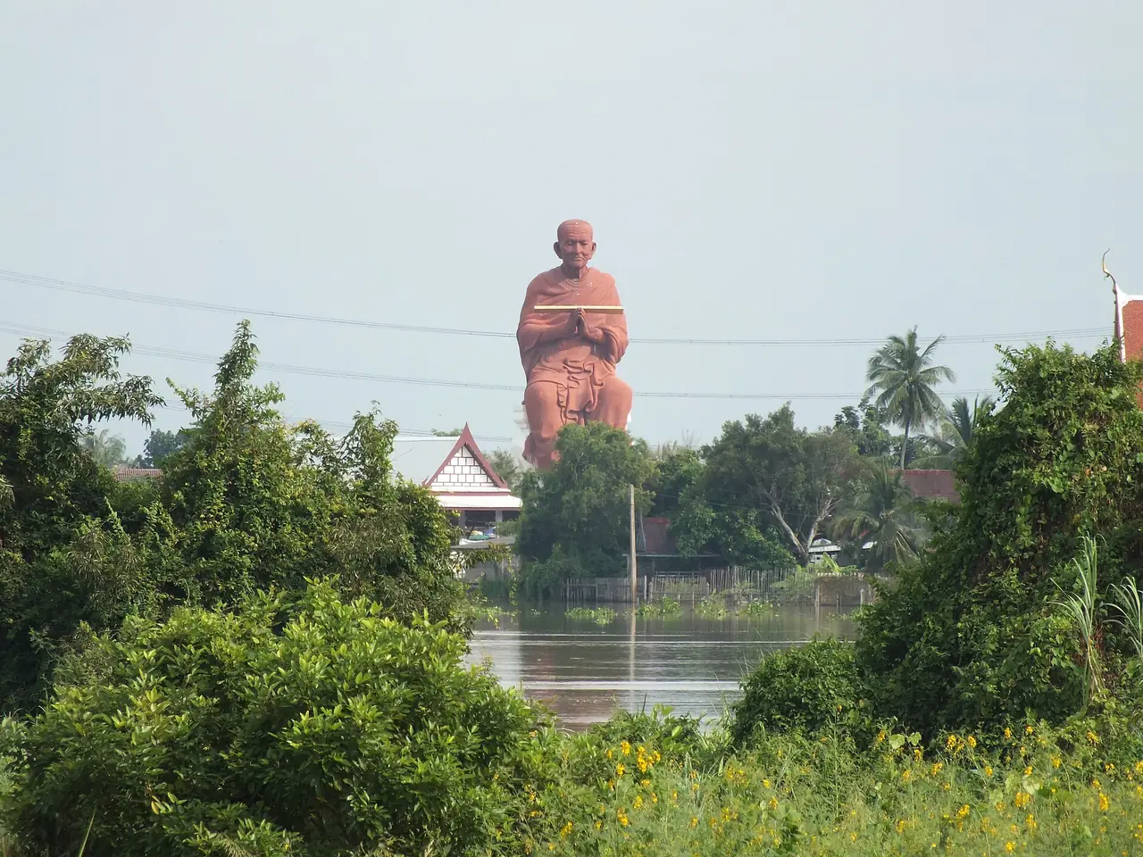 The large statue of the monk Somdet Phra Buddhacharn (To) near Wat Bot, Sam Khok, seen from a distance