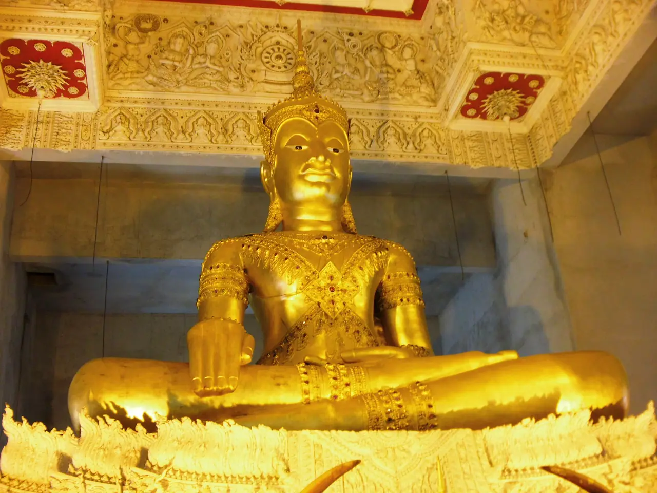 A golden Buddha image inside Wat Chedi Hoi in Lat Lum Kaeo district