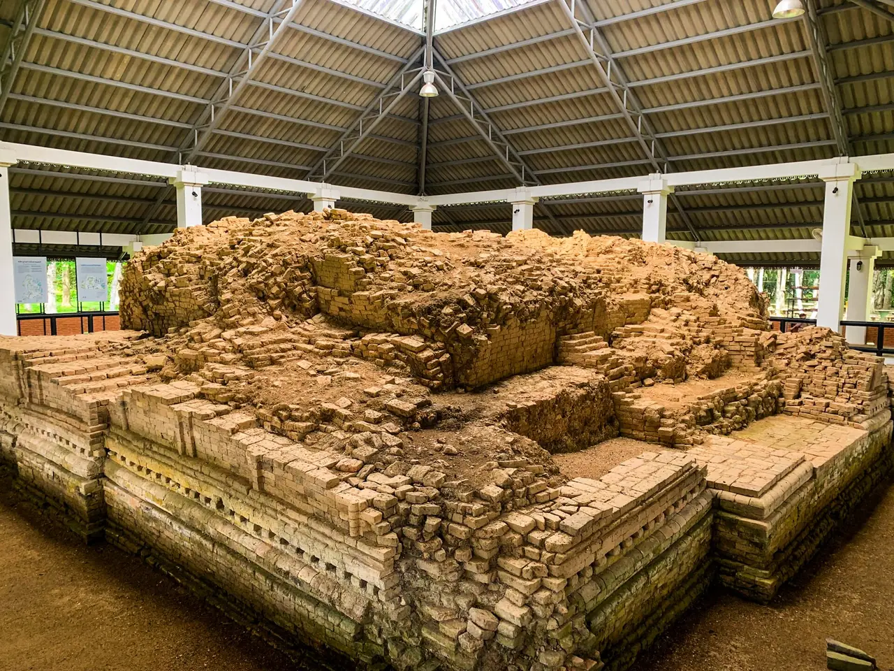 Brick foundations of an ancient structure under a protective roof at Yarang