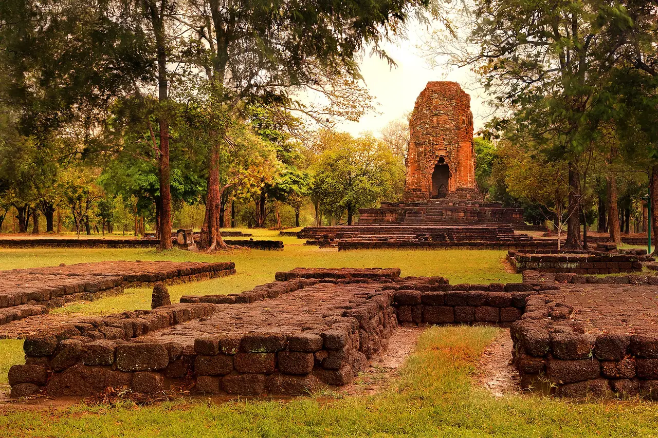 Prang Si Thep, a brick tower in Si Thep Historical Park, with ruined foundations in front