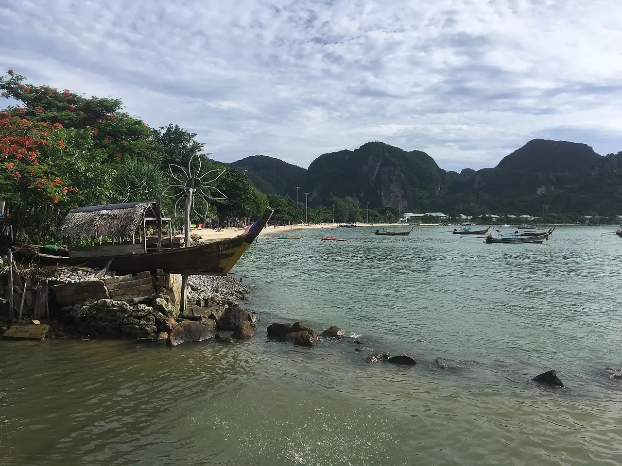 A view over Loh Dalum Bay on Phi Phi Don, with a longtail boat in the foreground