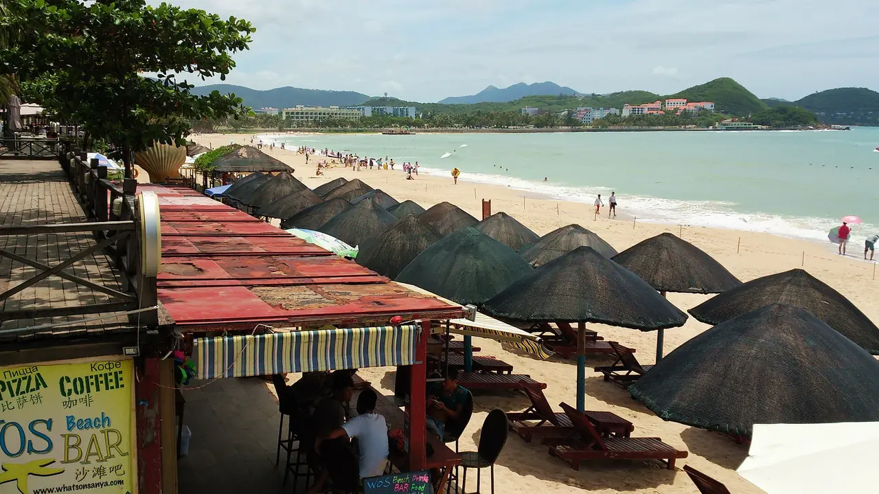 Dadonghai beach with beach cafes and umbrellas. Photo from Wikimedia Commons
