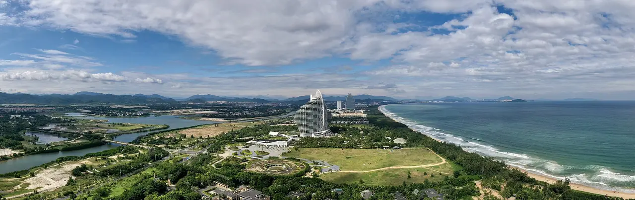 Panorama of Haitang Bay with its long shoreline and resort buildings. Photo from Wikimedia Commons