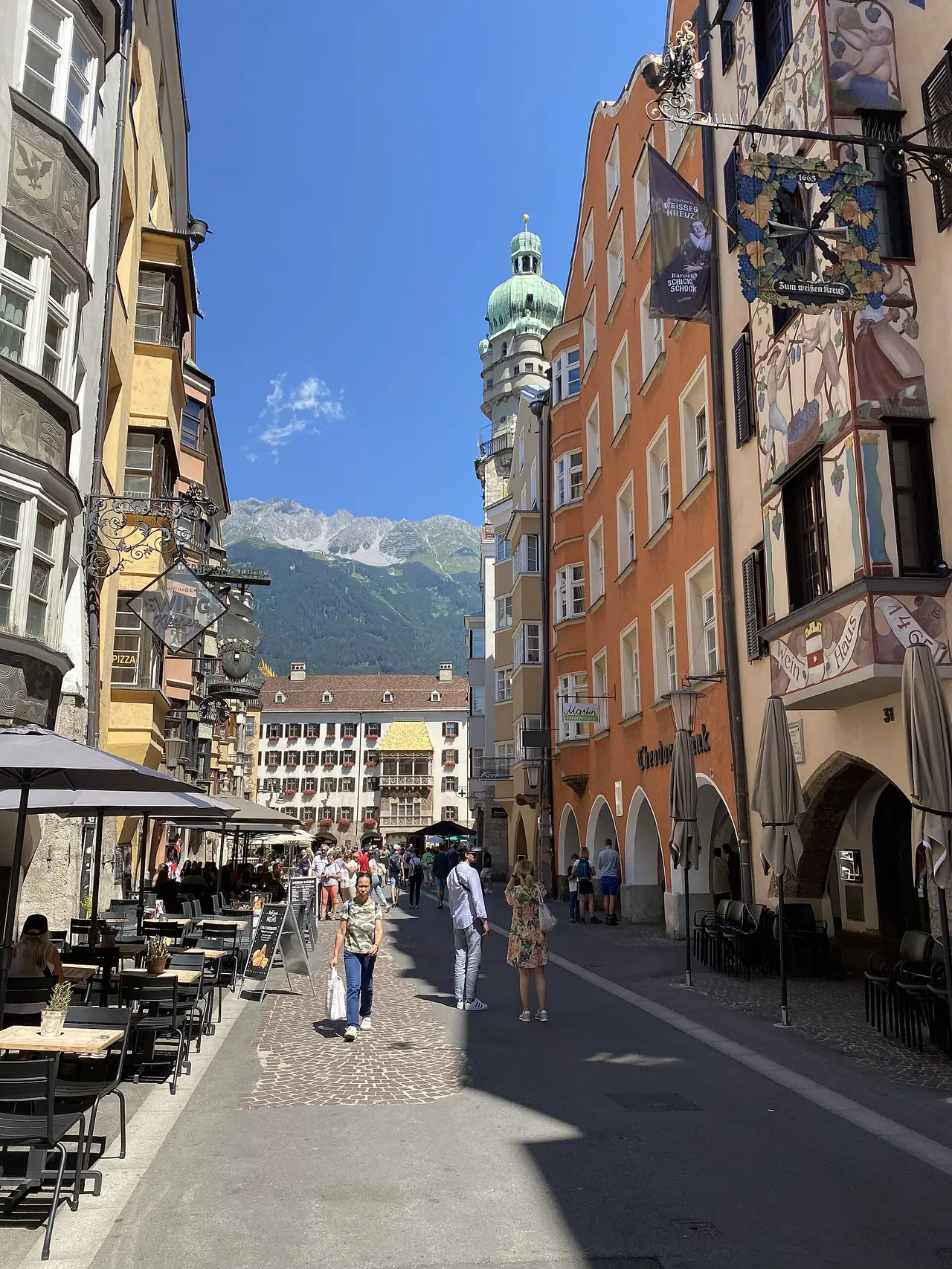 ถนน Herzog-Friedrich-Straße ในเมืองเก่า อาคารสีสันและป้ายร้านห้อยเหนือถนน ภาพจาก Wikimedia Commons ผู้ถ่าย -wuppertaler สัญญา CC BY-SA 4.0