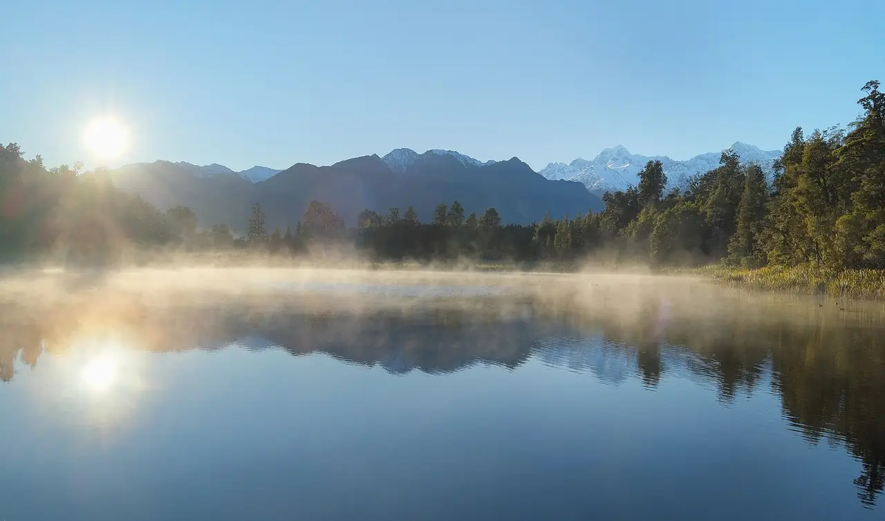 หมอกบางบน Lake Matheson ตอนพระอาทิตย์ขึ้น ภาพจาก Wikimedia Commons ผู้ถ่าย Pseudopanax สถานะ Public domain ไม่ระบุปี