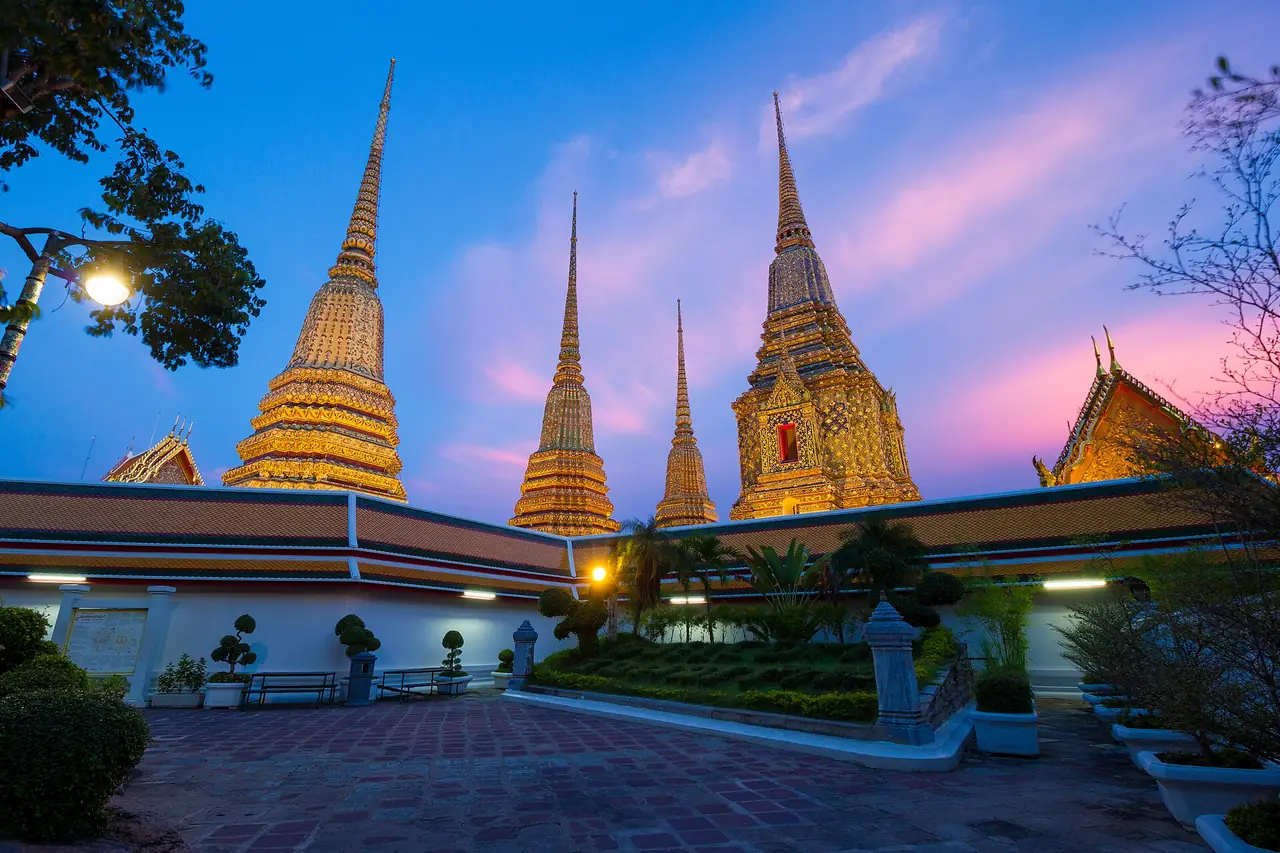 The tall chedis of Wat Pho at dusk, Bangkok