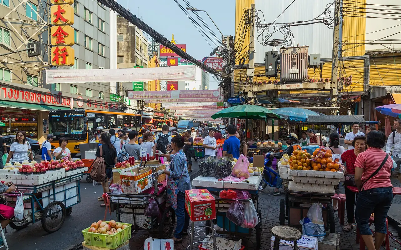 Fruit and produce carts and shoppers on Yaowarat Road, Samphanthawong District, Bangkok